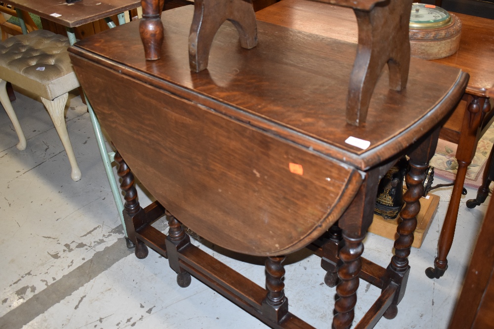 A traditional oak twist gate leg dining table