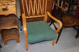 A vintage light stained ply armchair of stylised design, width approx 60cm , seat width approx 48cm