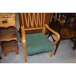 A vintage light stained ply armchair of stylised design, width approx 60cm , seat width approx 48cm