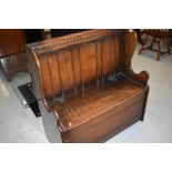 A traditional oak box settle, by Titchmarsh and Goodwin, labelled Siesta, retailed by NH Chapman and