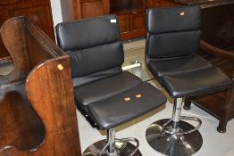 A pair of modern chrome and leatherette bar stools