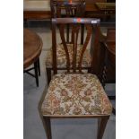 A pair of early 20th Century oak dining chairs having shaped slat backs and stuffed seats, real nice