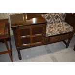 A traditional telephone seat having side panelled cupboard and under seat drawer, width approx.