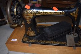 A traditional hand crank sewing machine by Singer