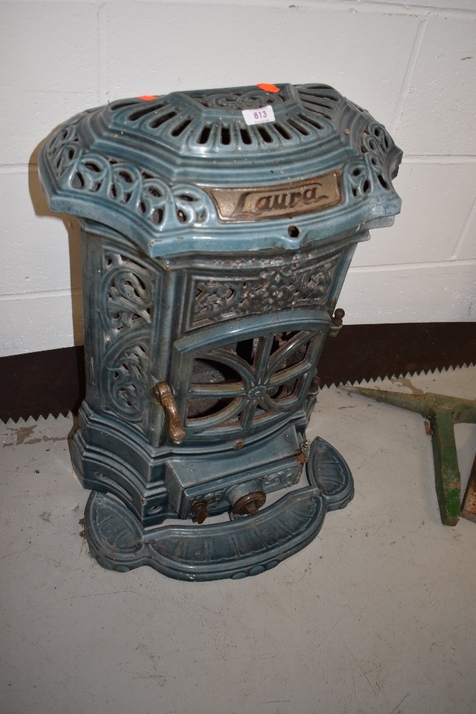 A vintage wood burning stove 'laura', a crosscut saw and a pair of anvil attatchments