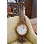 A late 19th/early 20th Century oak cased aneroid barometer of banjo form, dial marked Admiral