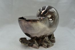 A silver plated spoon warmer modelled as a nautilus shell on rock base, with hinged lid and