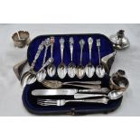 A cased part set of silver child's cutlery, similar spoon and fork, a selection of white metal