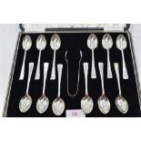 A cased set of twelve silver teaspoons with matching pair of sugar nips of plain form having stepped