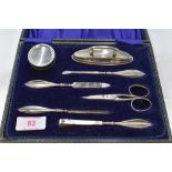 A cased vintage silver plated manicure set of traditional form