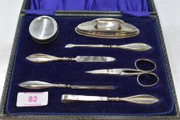 A cased vintage silver plated manicure set of traditional form