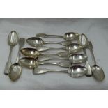 Eleven Georgian silver teaspoons of fiddle back form bearing monogram B to terminals, London 1831,