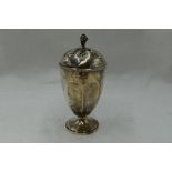 A silver caster of urn form having a pierced lid with pineapple finial, Birmingham 1926, Adie