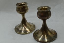 A pair of silver candle sticks of short plain form having bulbous shaped holders, Birmingham 1951,