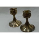 A pair of silver candle sticks of short plain form having bulbous shaped holders, Birmingham 1951,