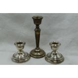 A pair of silver candle sticks of squat form, Birmingham 1976, W I Broadway, and a single silver