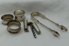 A small selection of HM silver including Victorian sugar nips, three napkin rings and travel