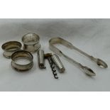 A small selection of HM silver including Victorian sugar nips, three napkin rings and travel