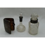 Two cut glass scent bottles with white metal and HM silver collars and glass stoppers and a small