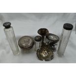 Five assorted glass dressing table pots having HM silver lids, a small HM silver bud vase and HM