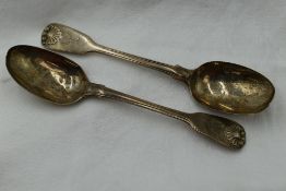 A pair of Georgian silver table spoons having moulded scallop shell decoration to terminals and