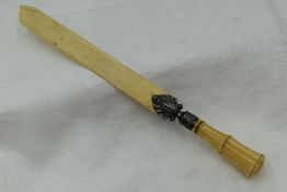 A Victorian paper knife/page turner having an ivory handle and silver fitting modelled as a