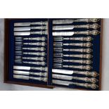 A mahogany canteen of Victorian silver handled dessert knives and forks (12 piece setting) having