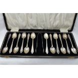 A cased set of twelve silver teaspoons of plain form bearing J monogram to terminals with matching
