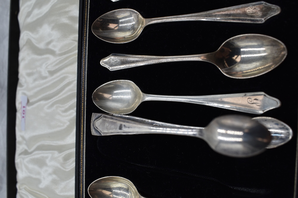A cased set of twelve silver teaspoons of plain form bearing J monogram to terminals with matching - Image 2 of 2