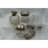 A selection of glass dressing table pots and a spherical cut glass scent bottle, all having HM