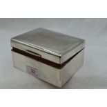 A silver cigarette box of plain form bearing presentation inscription to lid, Sheffield 1950, Walker
