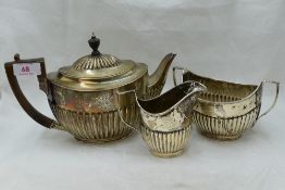 A Victorian silver three piece matched breakfast tea set of oval form having gadrooned decoration