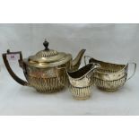 A Victorian silver three piece matched breakfast tea set of oval form having gadrooned decoration