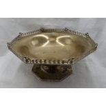 A silver tazza of hexagonal form having pierced foliate gallery rim and hexagonal pedestal foot,