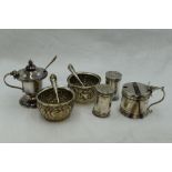 A selection of HM silver cruet items including a pair of pepperettes, a pair of salts and two lidded