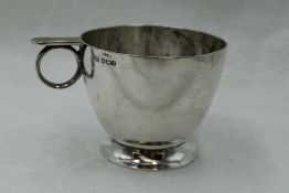 A silver Christening cup of plain form inscribed Michael having circular loop handle with thumb rest