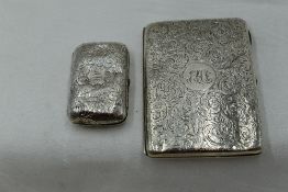 A Victorian silver aide memoire purse having engraved scroll decoration and monogrammed cartouche