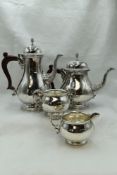 A modern silver four piece tea set of plain form with gadrooned circular pedestals, pineapple