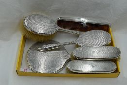 A six piece silver dressing table set having engine turned decoration and bearing monogram B to