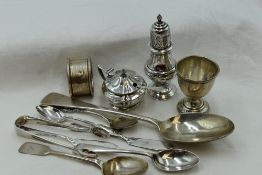 A selection of HM silver including two butter knives, egg cup, pepperette, mustard, table spoon,