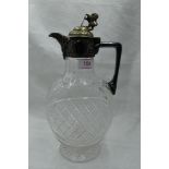 A cut glass claret jug of oval form having chequered decoration and plated handle and lid with