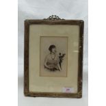A silver photograph frame of plain rectangular form having moulded ribbon detail to top and velvet