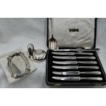 A cased set of HM silver handled butter knives, an HM silver ash tray of oval form, a silver
