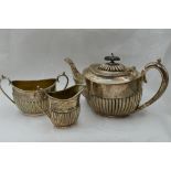 A Victorian silver three piece breakfast set of oval form having gadrooned decoration and loop