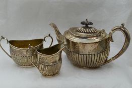 A Victorian silver three piece breakfast set of oval form having gadrooned decoration and loop