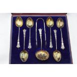 A cased set of six silver teaspoons with matching sugar nips and caster spoon, Birmingham 1899,