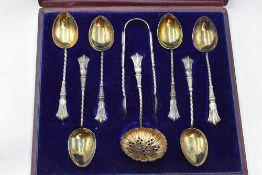 A cased set of six silver teaspoons with matching sugar nips and caster spoon, Birmingham 1899,