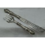 A pair of Victorian silver fish servers having moulded handles and pierced and engraved blades,