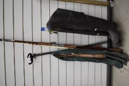 Two sea fishing rods, tripod rest and a pair of waders