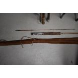 A three peice 10ft split cane fly rod with spare tip in canvas sleeve